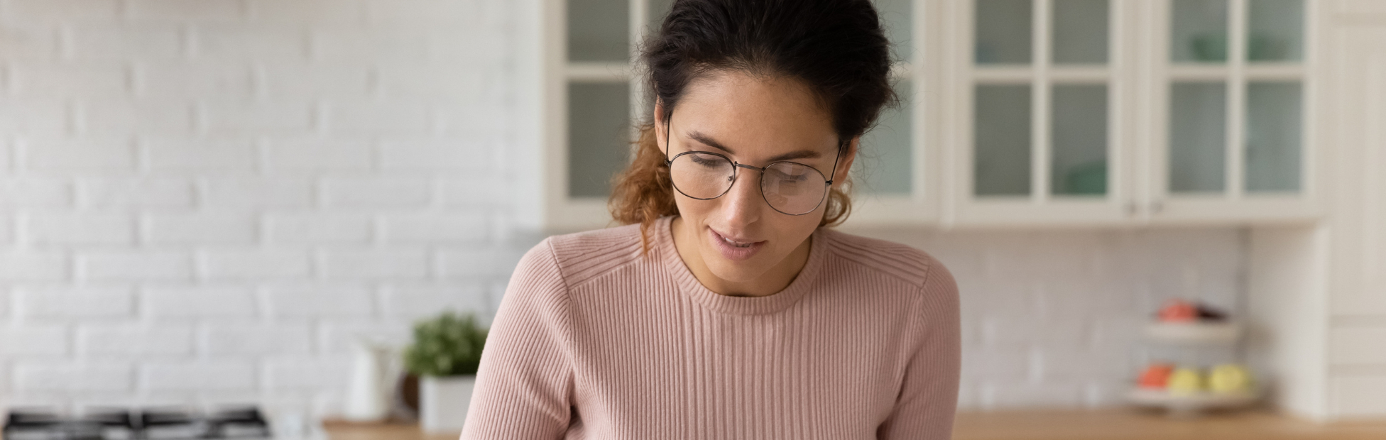 Confident woman in glasses counting bills, calculating budget at home