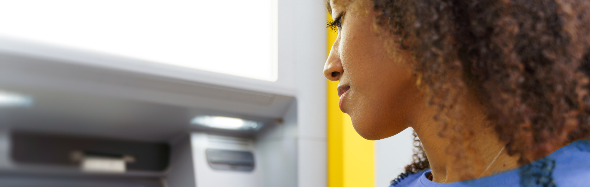 Young black woman banking at an ATM