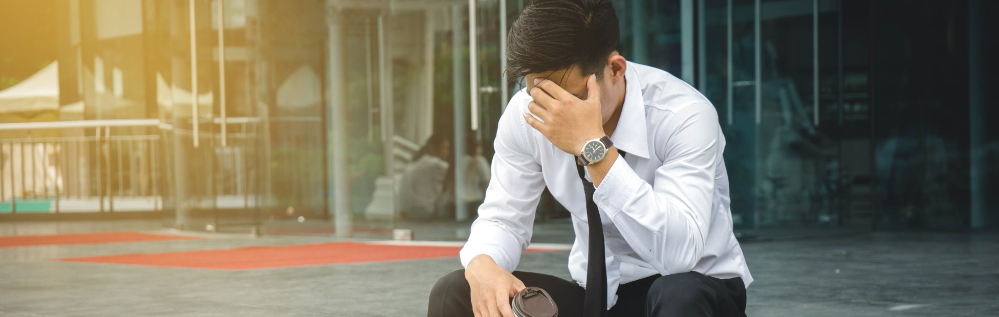 Unemployed businessman stress sitting on stairs outside office