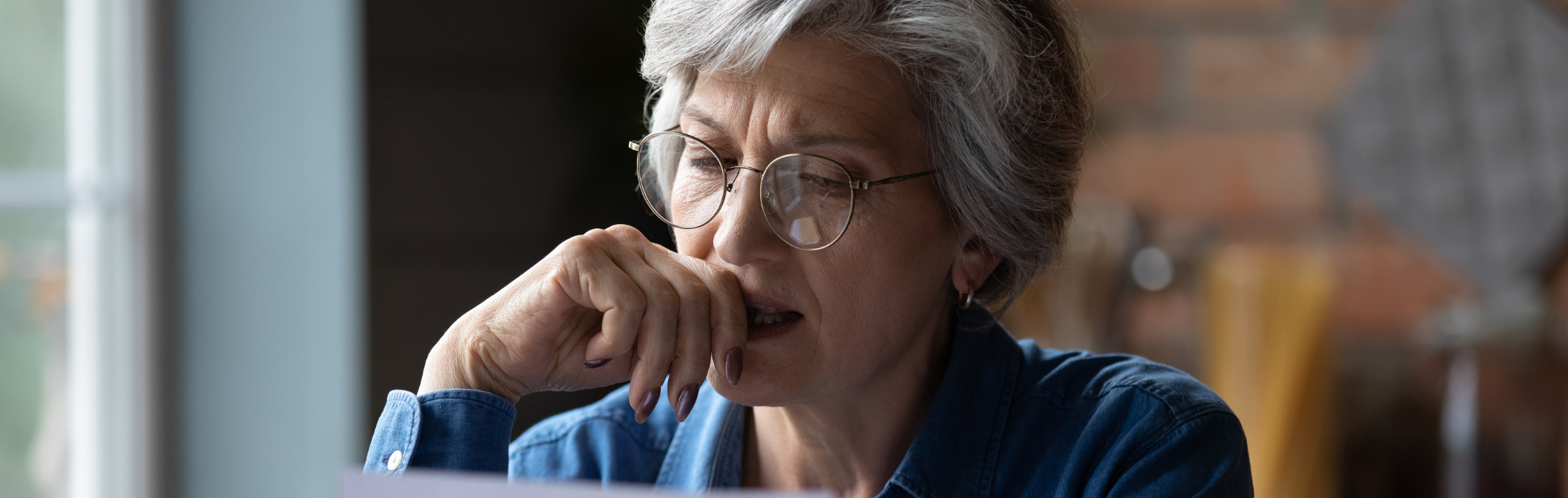 A middle-aged woman looking at a financial statement