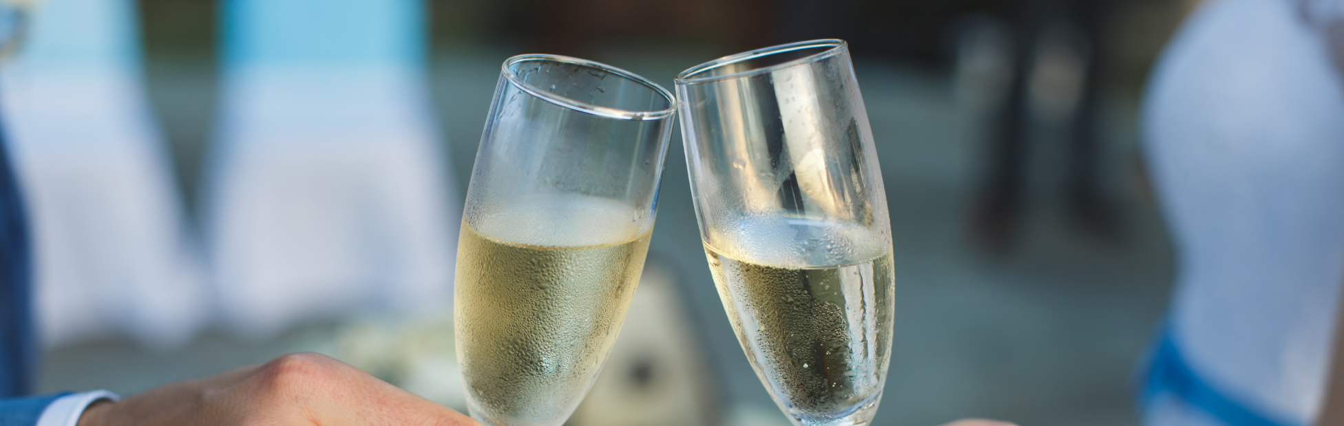 Close up of a couple clinking champagne glasses