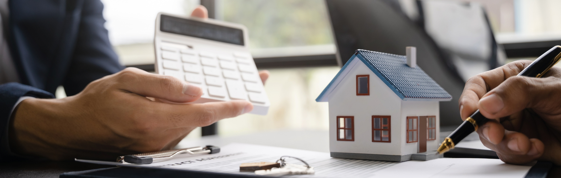 Realtor and client looking at numbers on a calculator