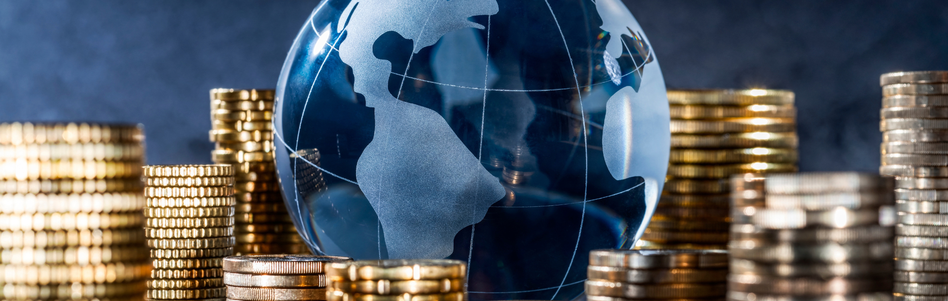 Glass globe surrounded by a stack with coins.