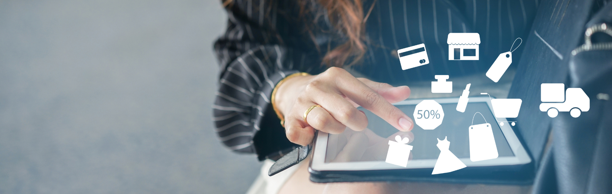 Out of focus Asian woman using tablet to select items in a marketplace website