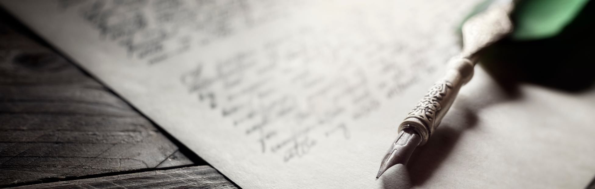 Green quill pen sitting on a last will and testament document