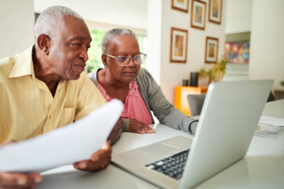 A smiling retired couple reviewing their financial statements