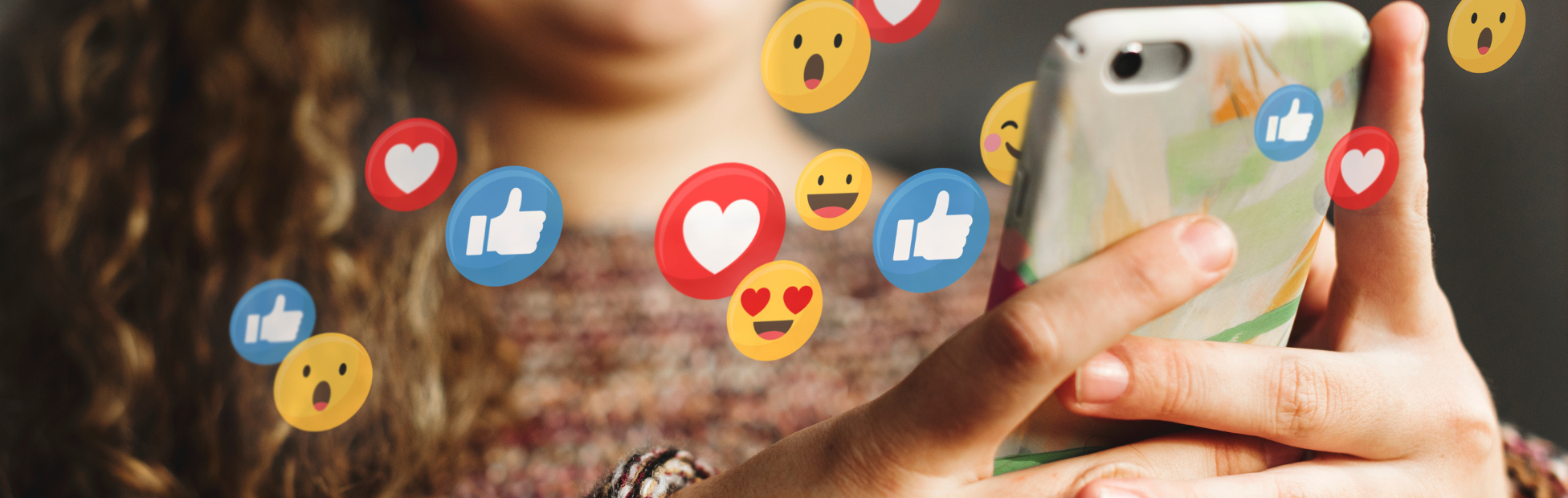 A teen using a smartphone with social media icons and emoticons floating in the air