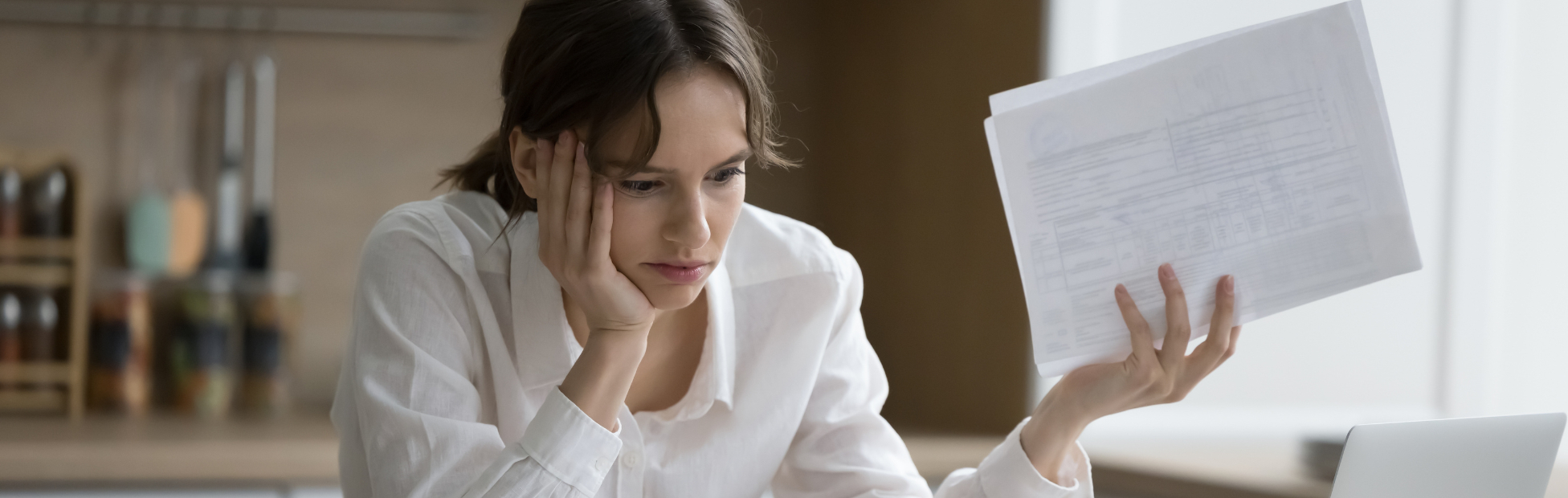 Stressed woman looking at her bills