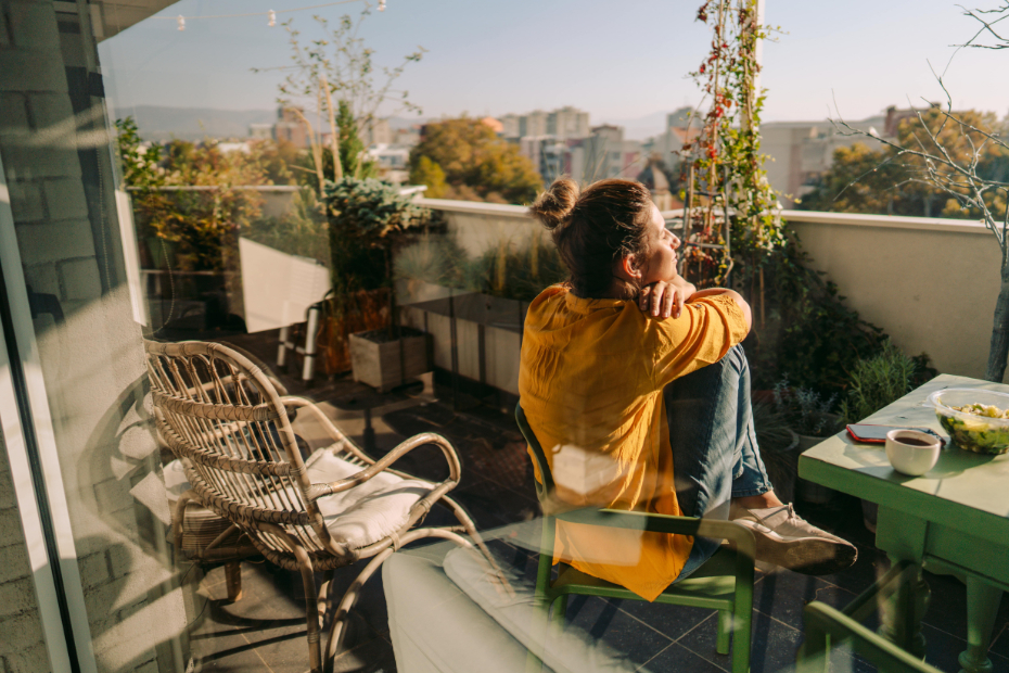 Person sitting on balcony of a condo