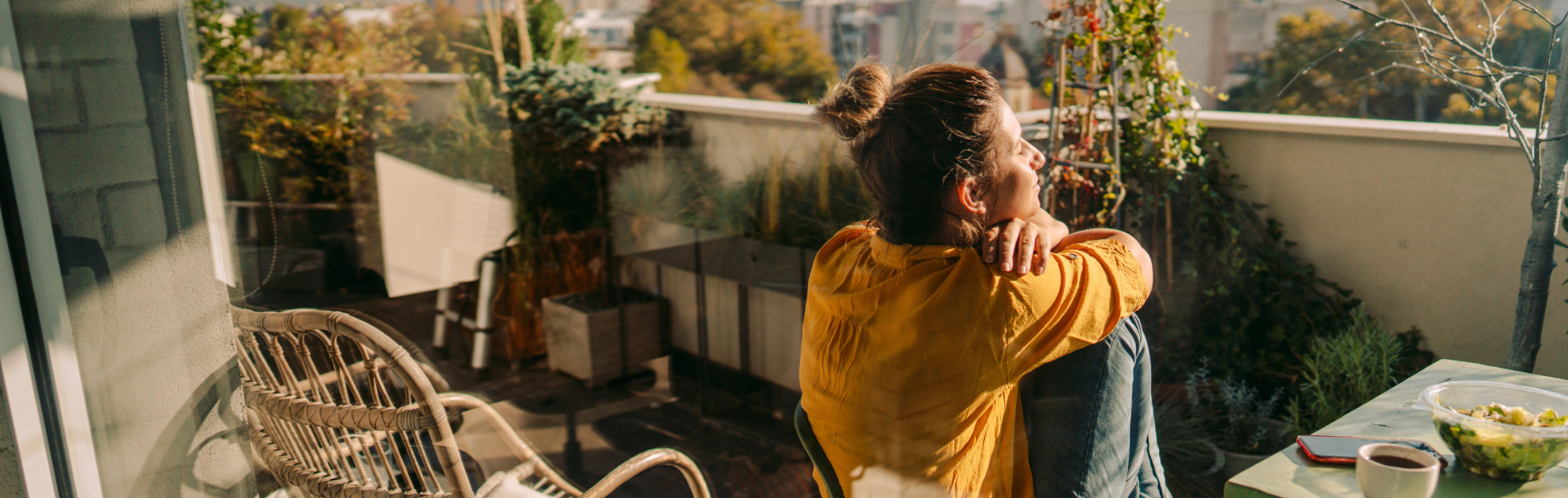 Person sitting on balcony of a condo