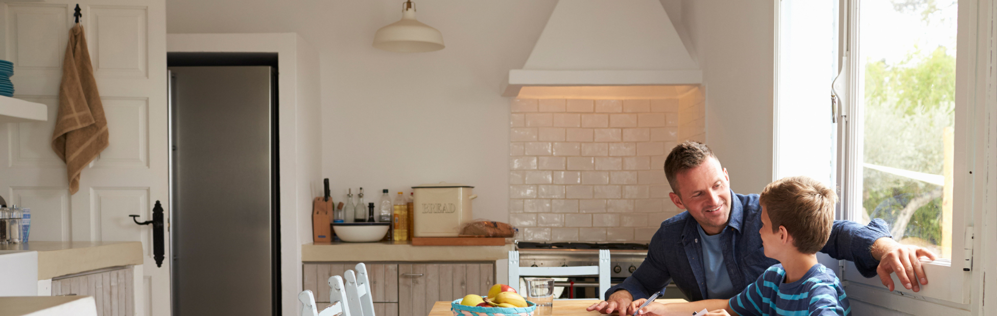 Father and son sitting in their newly renovated kitchen