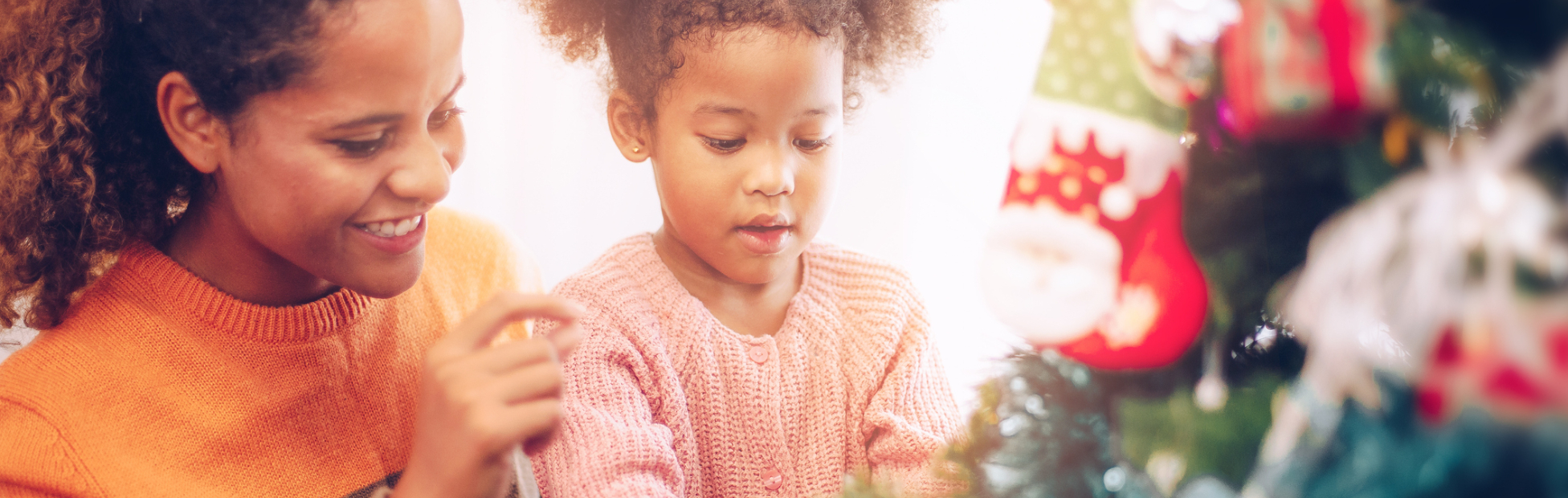 A mother and daughter near a Christmas tree
