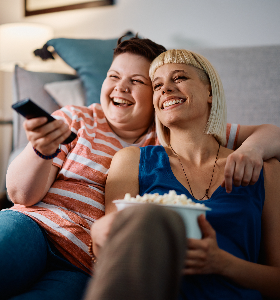 Two friends watching a movie with popcorn
