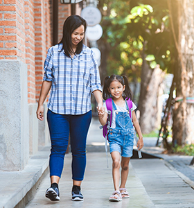 Girl and her mother walking