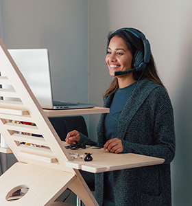 A woman working on a standing desk