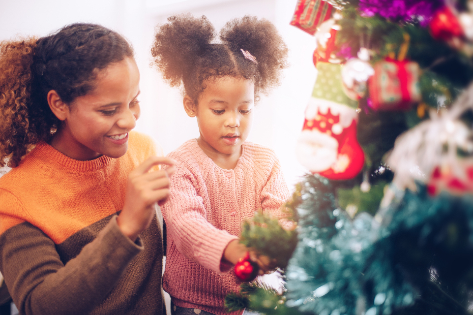 A mother and daughter near a Christmas tree