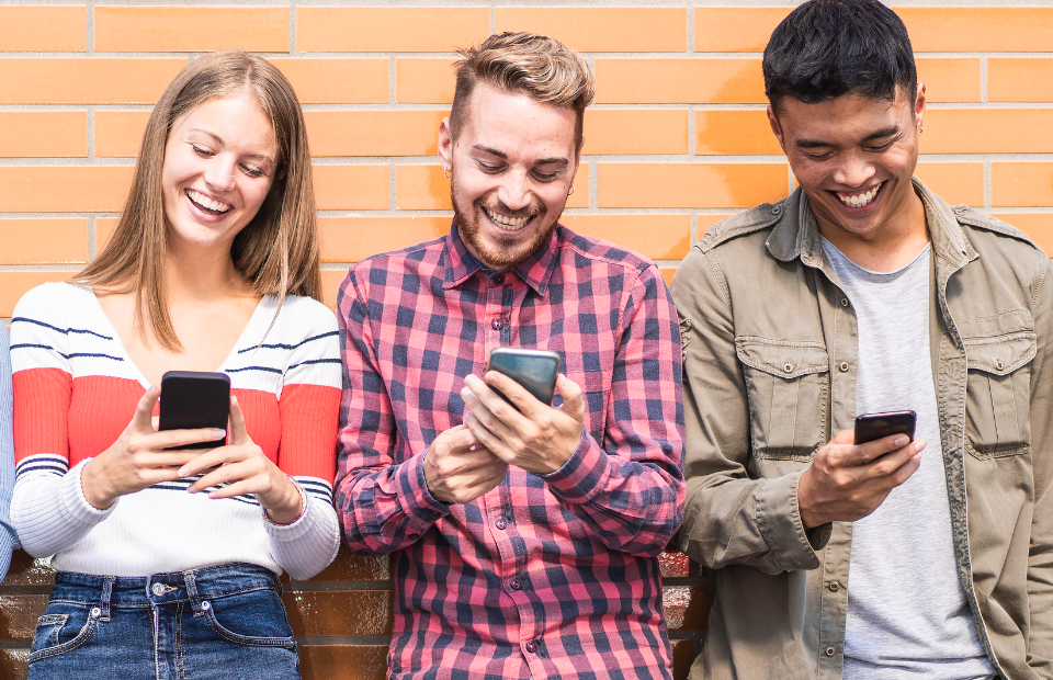 Friends looking at their phone together