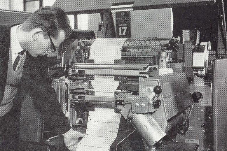 An employee reading a printout from RBCs first computer in 1962.