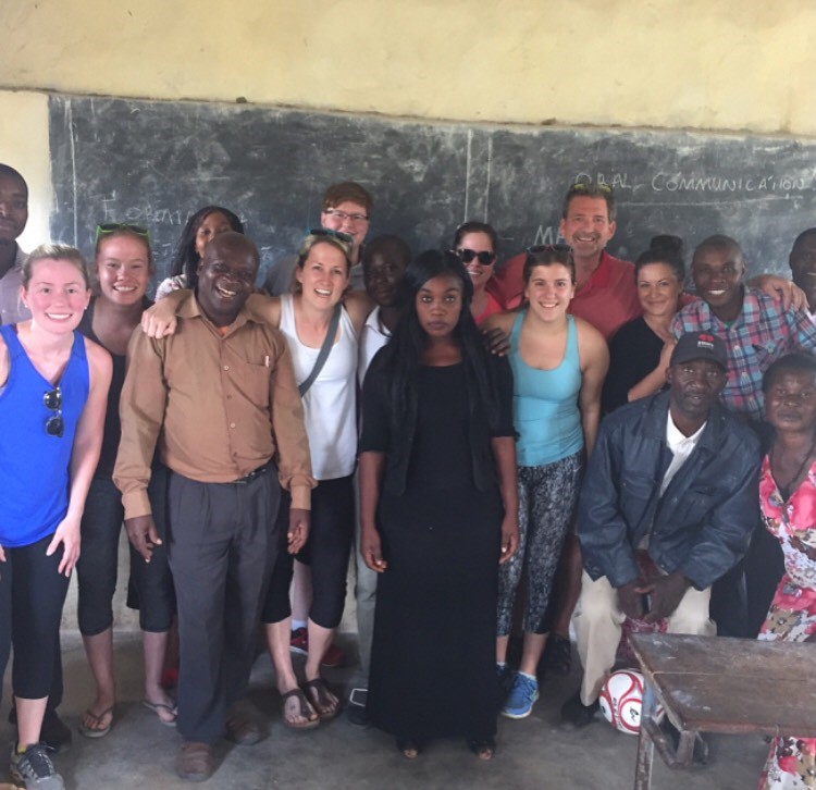 Megan Rizzo with Zambian villagers and Lambton College volunteers posing in a classroom